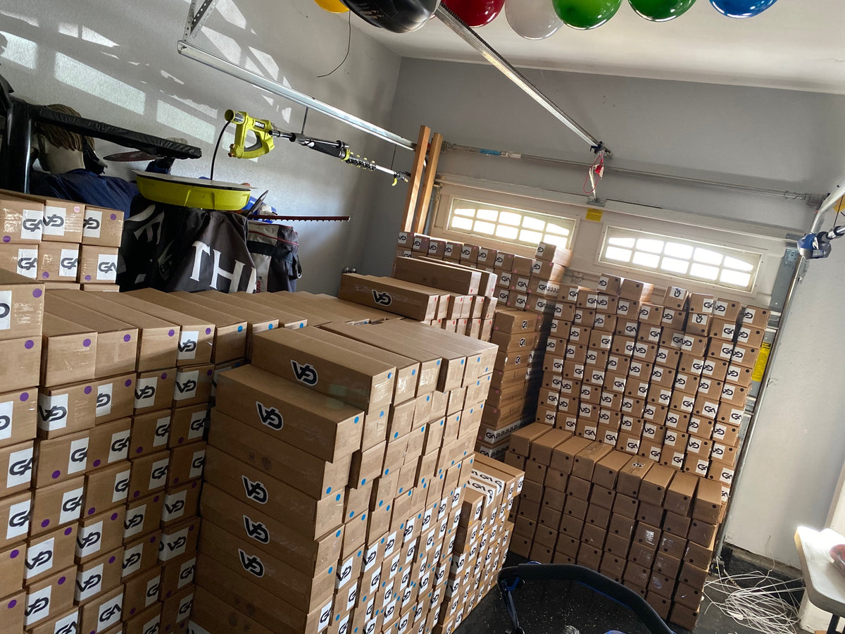 Stacks of GutzyAiden mousepad boxes filling the garage where the brand started